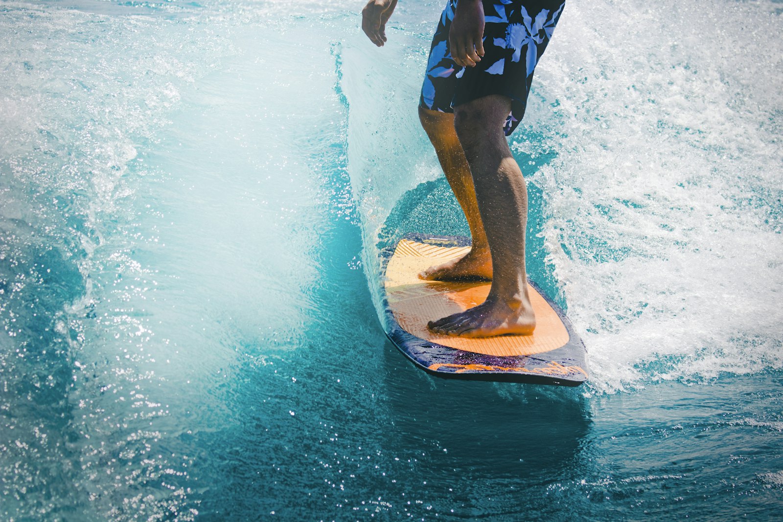 Surfer carving down the face of a tall wave